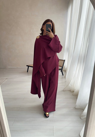 Elegant wine cape top coord with a gold brooch, featuring a flowy modest silhouette. Perfect for Eid abayas, wedding guest gowns, and formal occasions.